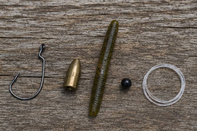 The four essential components of a Texas rig — hook, weight, bait, and line