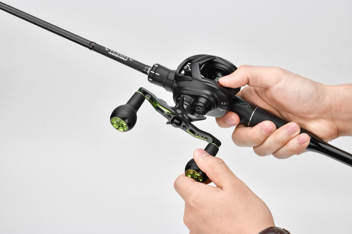Angler's hands operating a black and lime-green baitcasting reel