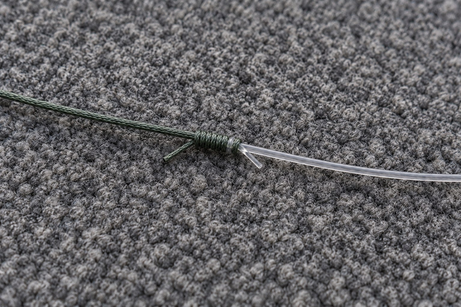 Finished FG knot where braided line meets fluorocarbon leader, held between two fingers